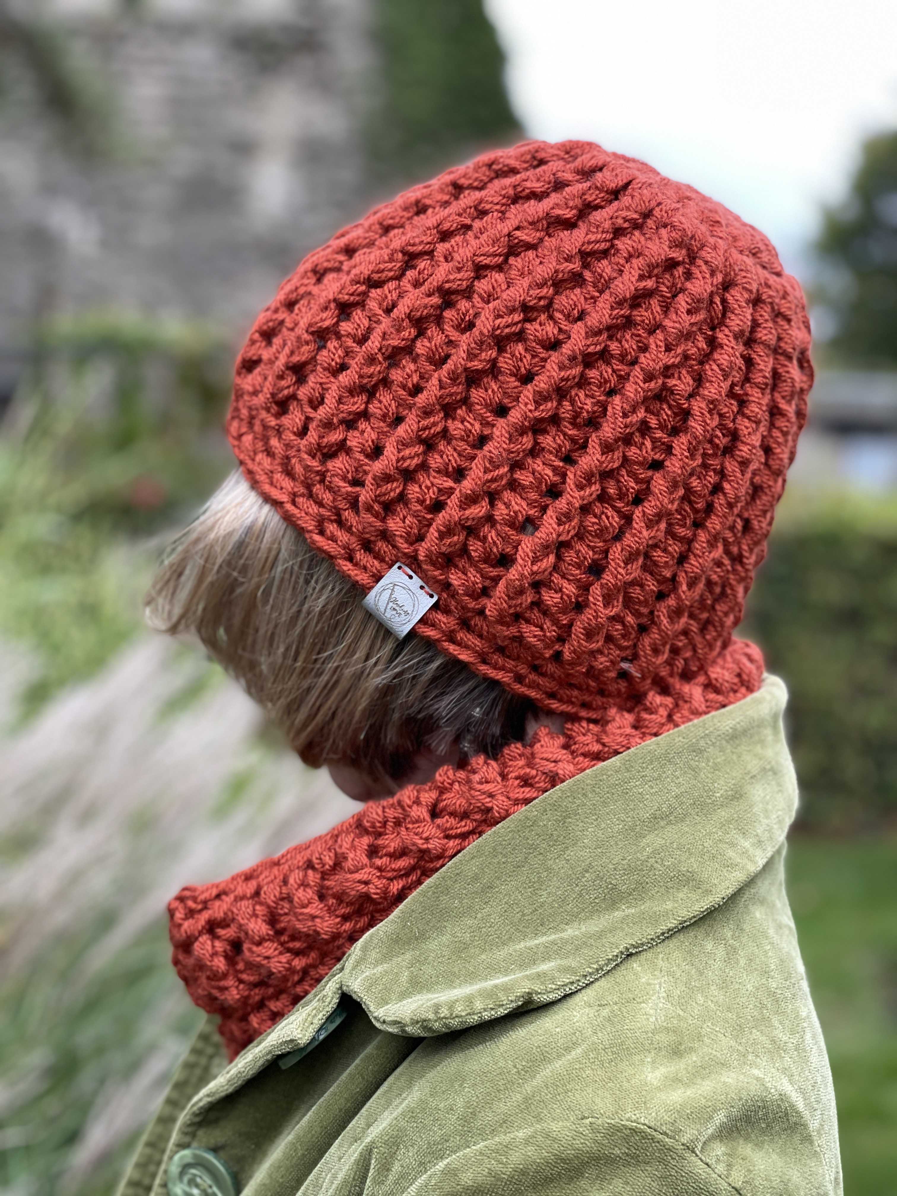 Hat and Cowl Set worn by Sarah with a green landscape behind